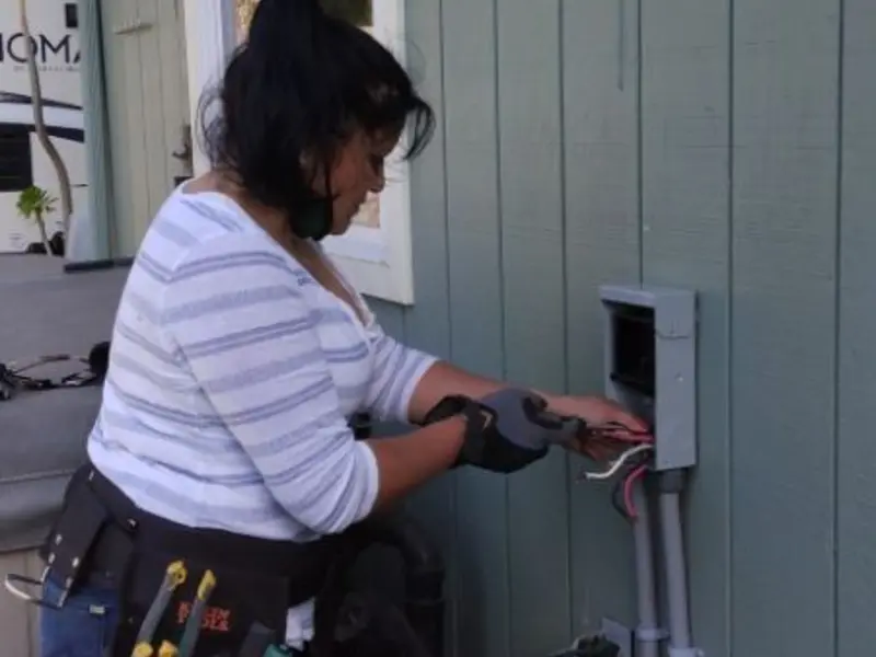 Licensed electrician wiring an exterior subpanel in Sunset